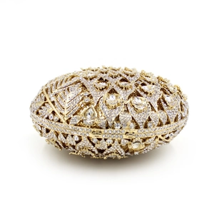 Elegant gold hollow metal evening clutch bag with sparkling white crystal rhinestones