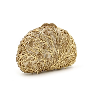 Detail of golden evening clutch with leaf metal frame and shimmering crystal rhinestones