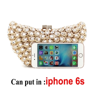 Luxurious champagne gold rhinestone clutch bag with hollow metal patterns fitting a phone