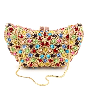 Detail of floral crystal clutch featuring colorful rhinestones and gold snake chain