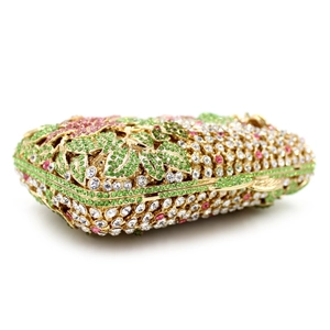 Close-up of luxury hollow metal evening bag with colorful crystals and flower patterns