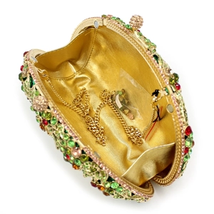 Detailed interior of hollow metal clutch with colorful rhinestones and gold chain