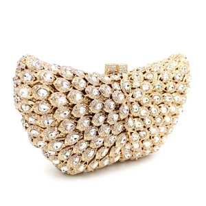 Detail of a luxury evening clutch showing intricate radial rhinestone patterns and gold clasp