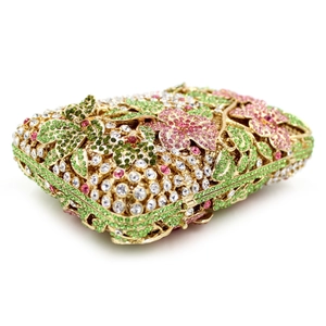 Detailed close-up of colorful rhinestone floral patterns on a hollow metal evening clutch bag