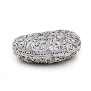Detailed view of silver hollow floral metal design with crystal rhinestones on clutch