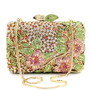 Detailed macro view of the crystal floral evening bag showing pink and green rhinestone patterns