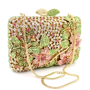 Close-up of floral crystal evening clutch with butterfly clasp and gold metal chain