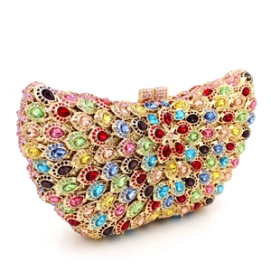 Detailed side view of luxury evening clutch with colorful peacock feather rhinestone patterns