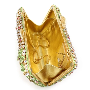 Macro view of crystal evening clutch with green rhinestones and gold chain