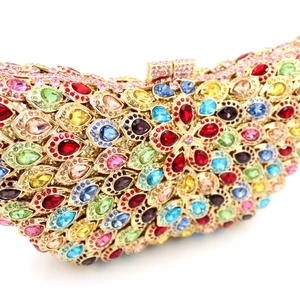Detailed macro view of colorful rhinestones and gold metal frame on an evening clutch bag