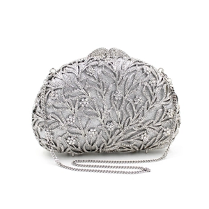 Detail of silver rhinestone clutch bag with hollow metal floral mesh and chain strap