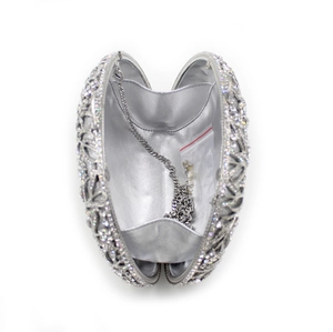Top view of silver rhinestone clutch interior with metal chain and spare crystal beads