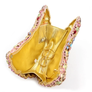 Macro view of crystal rhinestone evening clutch interior with detachable gold chain strap