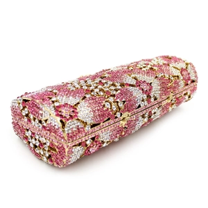 Close-up of pink and white floral rhinestone pattern on a metallic evening clutch bag