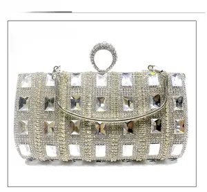 Detail of luxury bridal clutch featuring a ring handle and radiant rhinestone accents