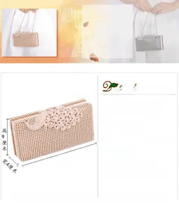Detailed view of luxury peacock diamond evening clutch bag with metallic chain strap