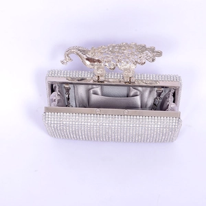 Detail of silver rhinestone evening clutch bag with peacock clasp and metal chain