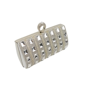 Detail of silver evening clutch featuring crystal rhinestones and diamond ring clasp handle