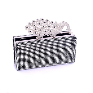 Detailed view of the black evening clutch with rhinestone peacock clasp and crystals