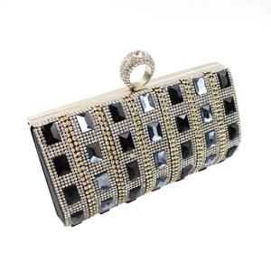 Macro detail of rectangle clutch bag featuring blue crystal stones and ring clasp