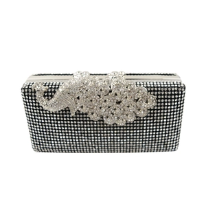 Detailed view of luxury peacock clasp and silver rhinestones on black evening clutch