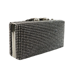 Detailed macro view of the silver metallic frame and sparkling crystal rhinestones on the bag