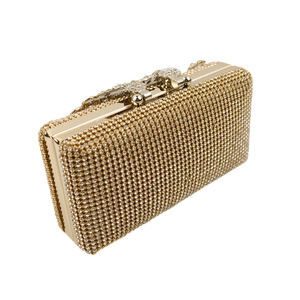 Detailed close-up of golden evening clutch featuring crystal pavé and floral clasp
