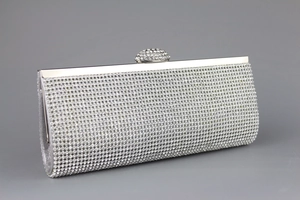 Macro shot of sparkling silver crystal evening clutch with metallic frame and diamond clasp