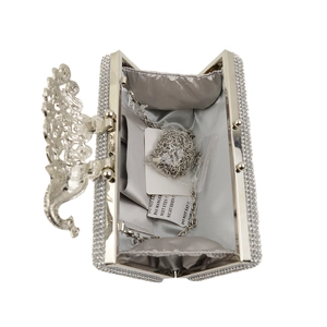 Detail of silver evening clutch interior with satin lining and detachable chain strap