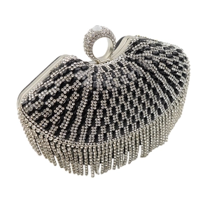 Detail of black rhinestone evening clutch with diamond ring handle and long crystal tassels