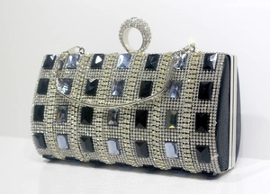 Detailed side view of silver rhinestone evening clutch with gemstone embellishments