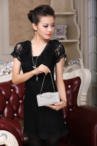 Close-up of silver evening clutch bag featuring intricate diamond floral rhinestone pattern