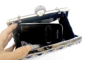 Detailed interior of a crystal evening clutch featuring a ring clasp and metal chain