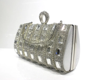 Silver evening clutch with rhinestone ring handle and crystal encrusted exterior detail