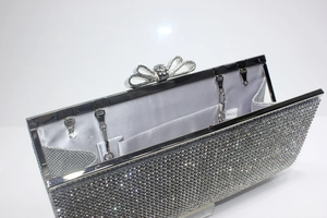 Detail of silver rhinestone evening bag interior with satin lining and metal chain