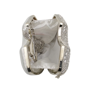 Detailed view of silver evening bag with rhinestones, satin lining and chain strap