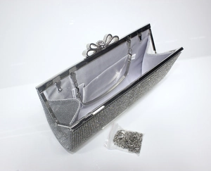 Silver rhinestone evening clutch bag with bow clasp and interior satin lining with chain