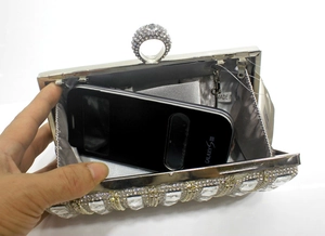Silver evening clutch with diamond rhinestones showing interior capacity for a phone