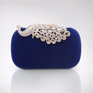 Detail of navy velvet evening clutch featuring an intricate crystal peacock decoration