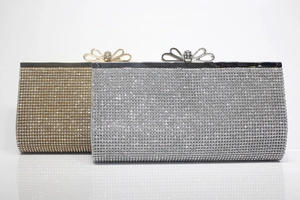 Detail of evening clutch bags in gold and silver with rhinestones and bow clasp