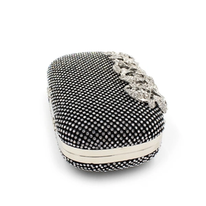 Detail of luxury evening clutch with sparkling leaf crystals and silver metal frame