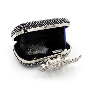 Detail of black rhinestone clutch with silver chain and internal satin lining