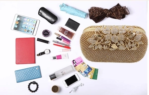 Detailed view of the gold evening bag showcasing its capacity to hold daily essentials