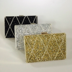 Detailed view of rhinestone evening clutch bags in silver gold and black diamond patterns