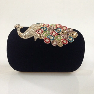 Detail of colorful peacock rhinestone encrusted on black velvet evening clutch bag