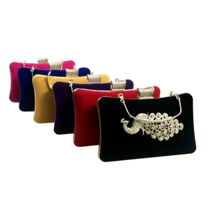 Close-up of velvet evening bags with rhinestone peacock designs in six vibrant colors
