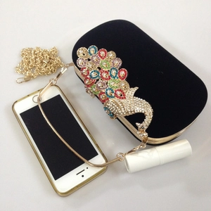 Detailed view of peacock evening bag with phone and lipstick to show internal size
