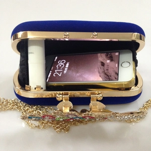 Detailed interior of blue velvet clutch showing space for phone and lipstick