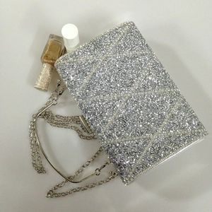 Macro view of silver diamond evening clutch with geometric rhinestone patterns and chain