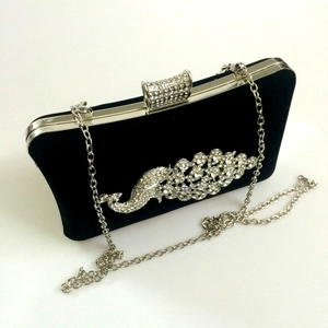 Elegant black velvet clutch bag featuring a sparkling peacock rhinestone design and chain